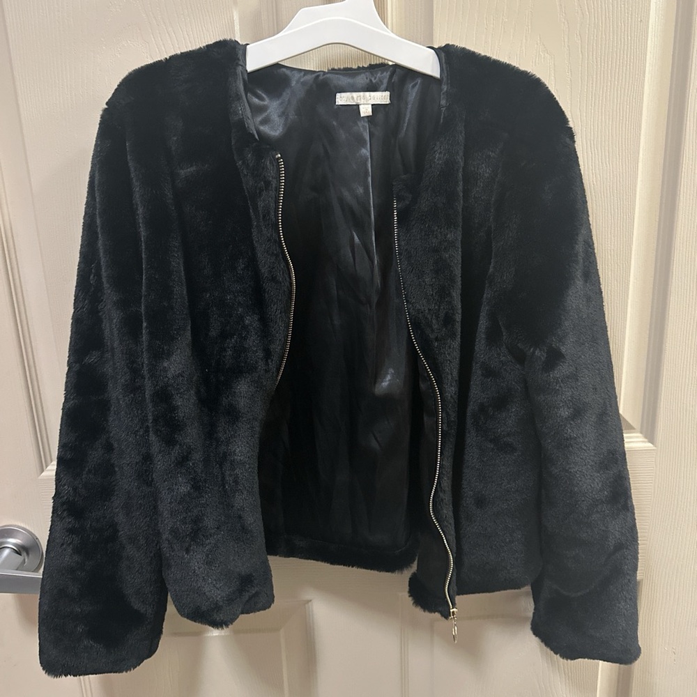 Small black furry light jacket.
